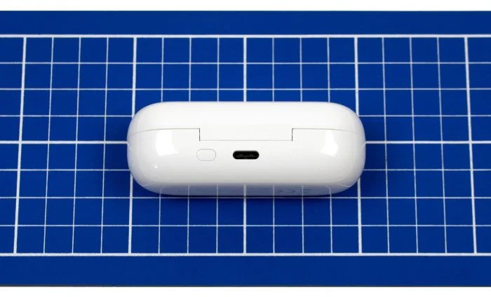 Opladetaske med USB-C-stik og parringsknap.