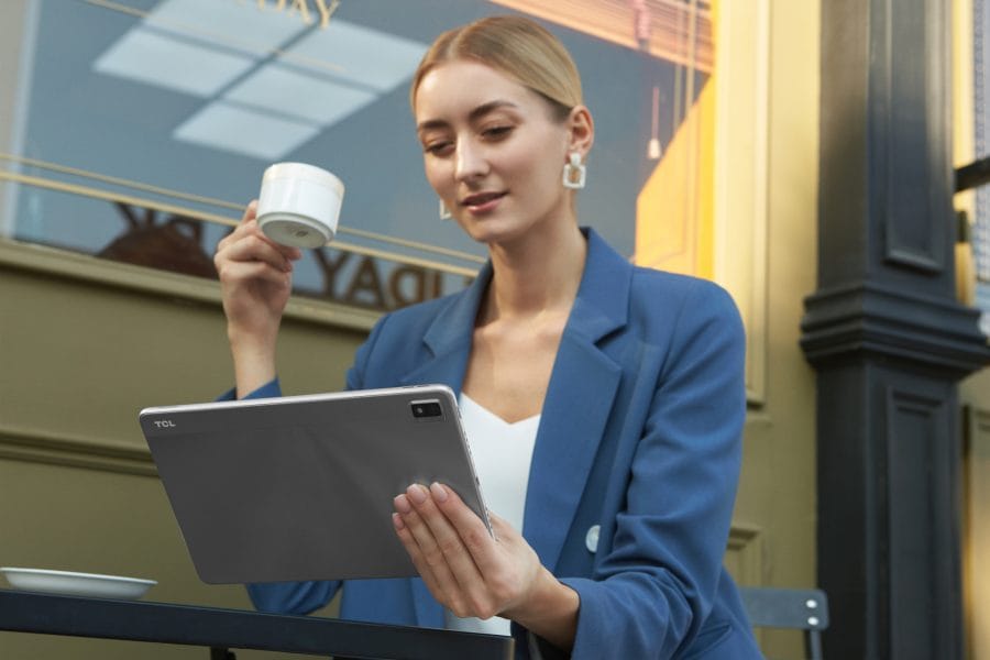 TCL TAB MAX 10.4 tablet held by woman.